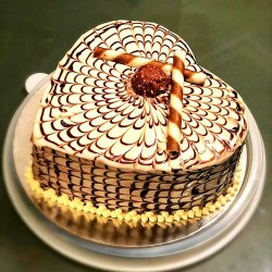 Heart shape butterscotch cake with ferrero rocher topping