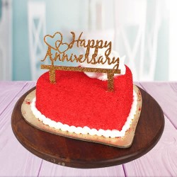 Heart shape red velvet cake with happy anniversary topper