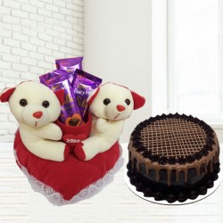 Cute couple teddy with chocolates and chocolate cake