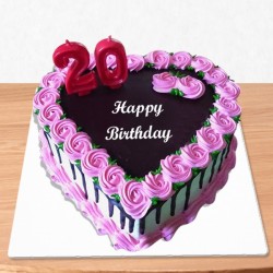 Flowery heart shape birthday cake with number candles