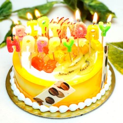 Fruit cake with happy birthday candle
